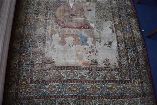 A 19th century Persian ivory ground pictorial rug, depicting a Shah, 6ft 9in by 4ft 7in.